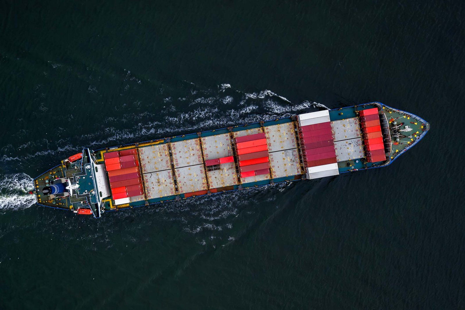 Aerial view of a fully loaded container ship underway at sea